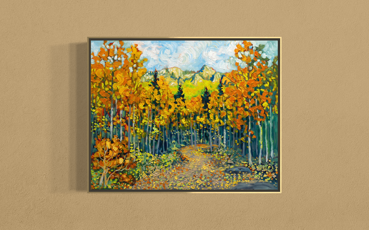 A framed vertical canvas painting of an autumn forest path, featuring vibrant orange and yellow trees, green and blue mountains in the background, and a swirling sky, displayed on a textured beige wall.